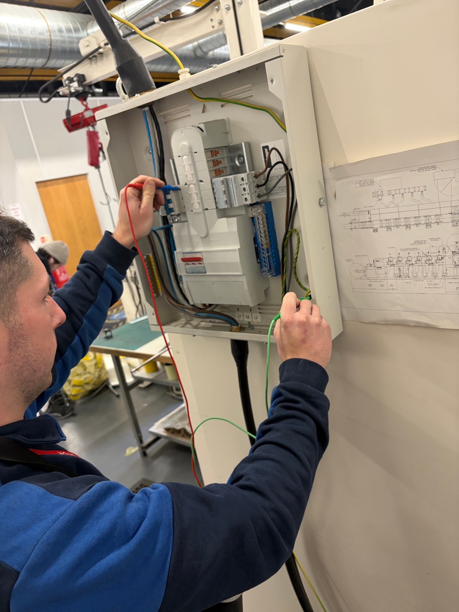 Electrician carrying out commercial electrical work